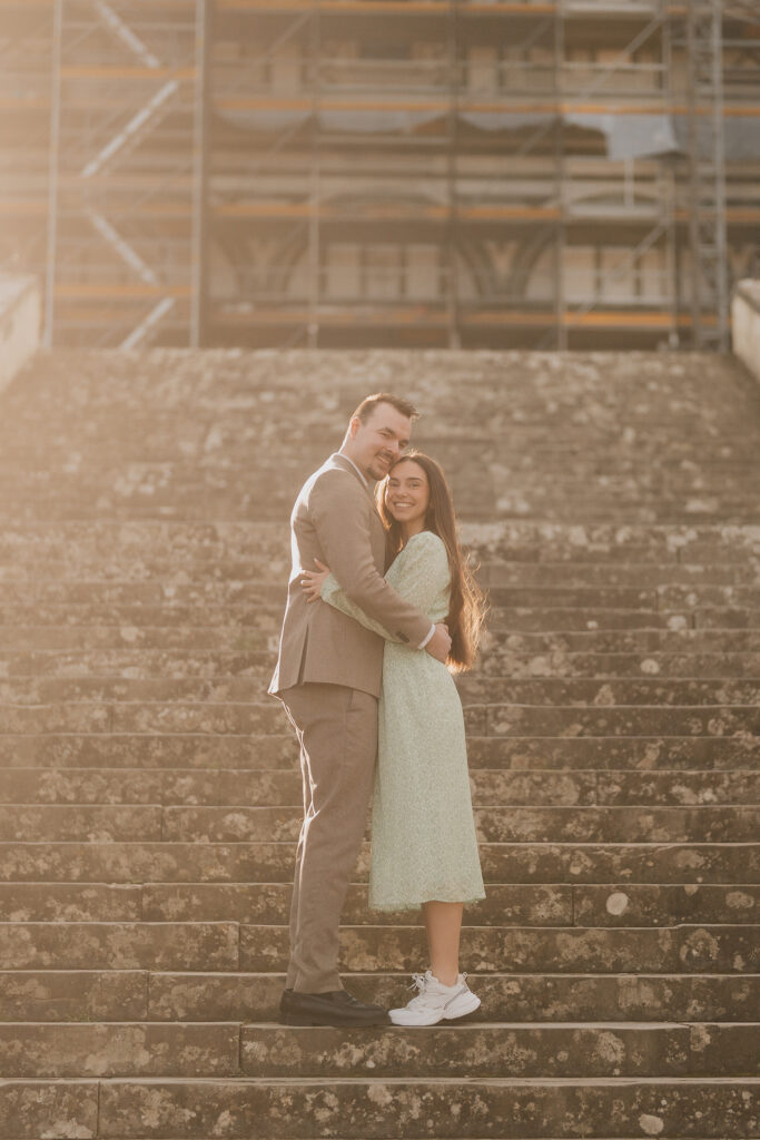 Florence proposal photoshoot: the couple embracing on stone steps in the evening light