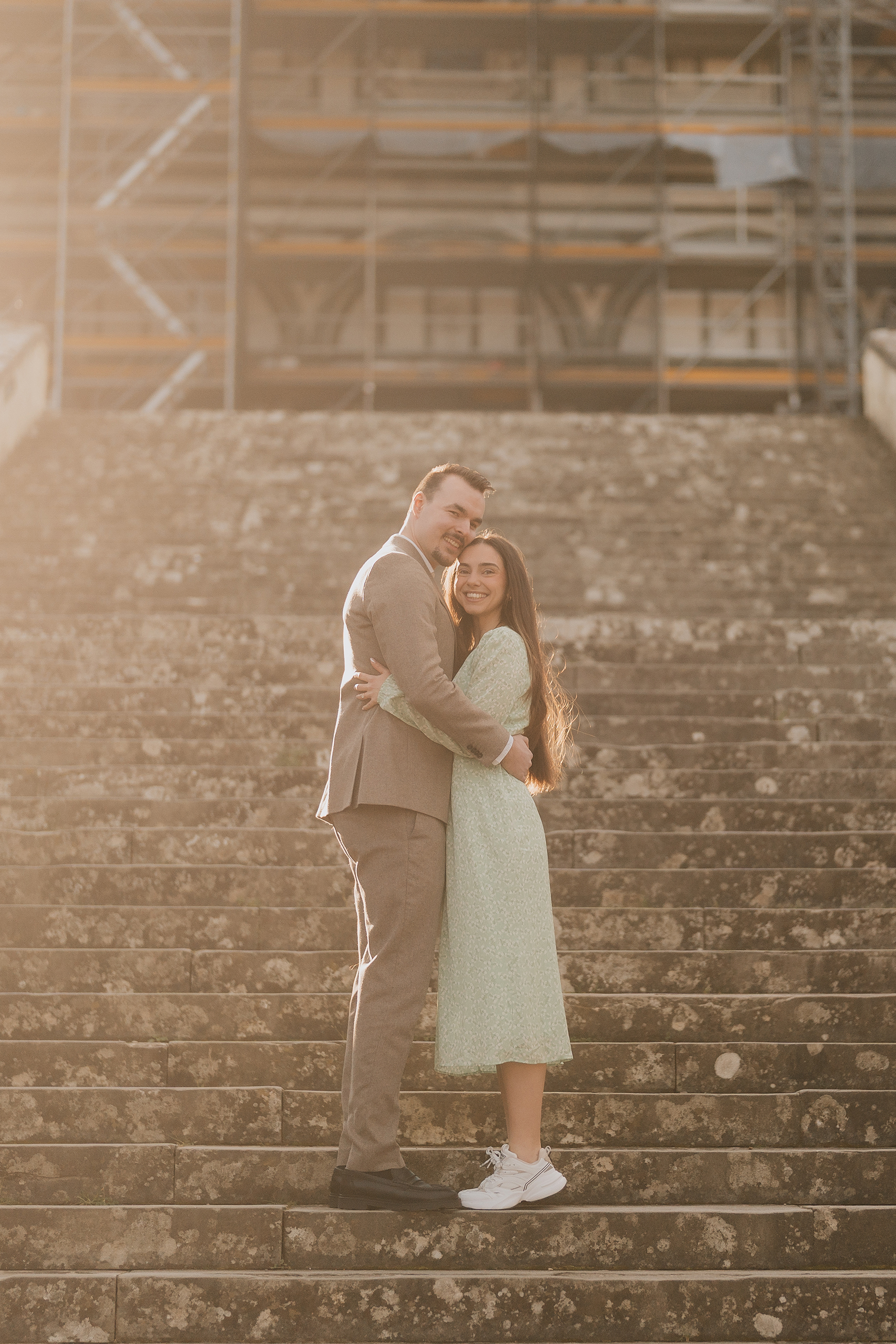 Couple embracing on stone steps during proposal photoshoot in Florence at sunset