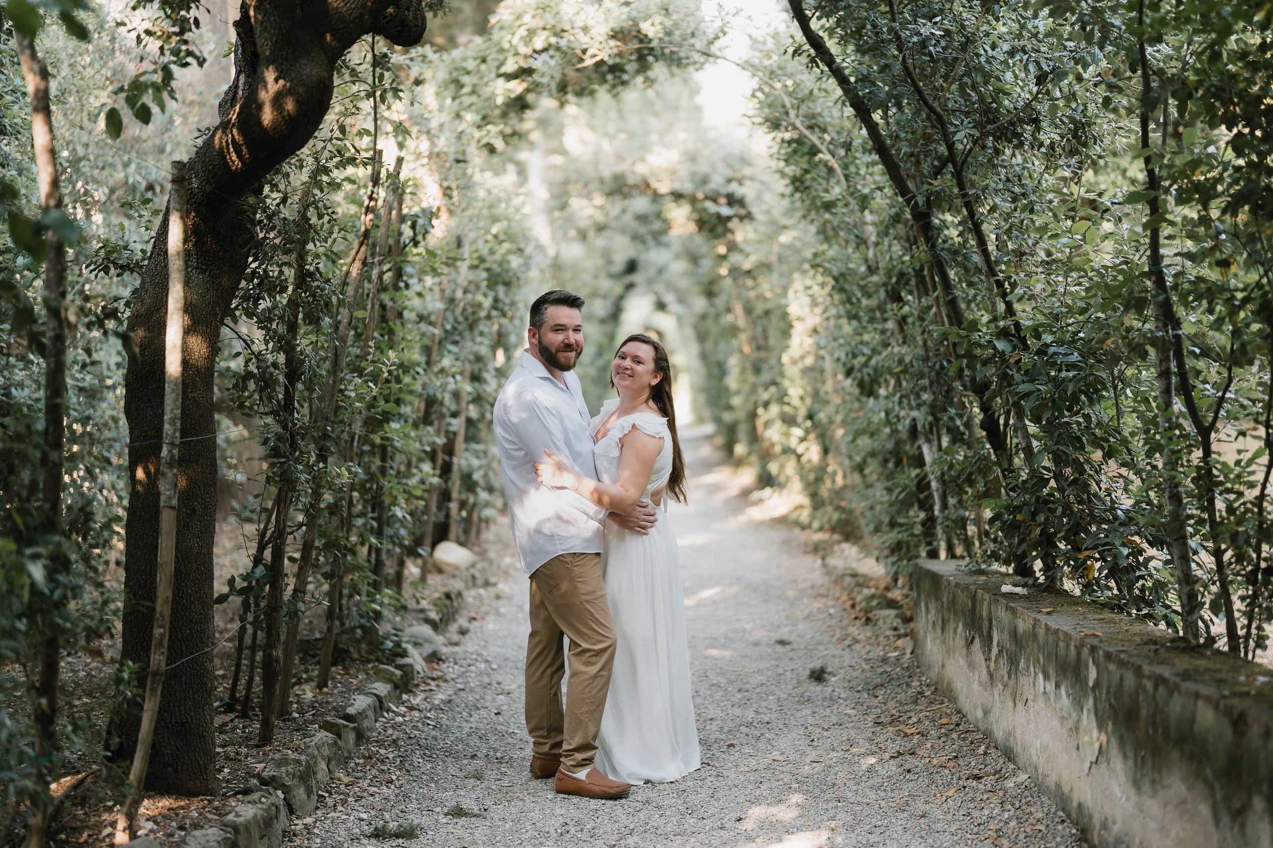Couple embracing on a shaded path of the Boboli Gardens, Florence