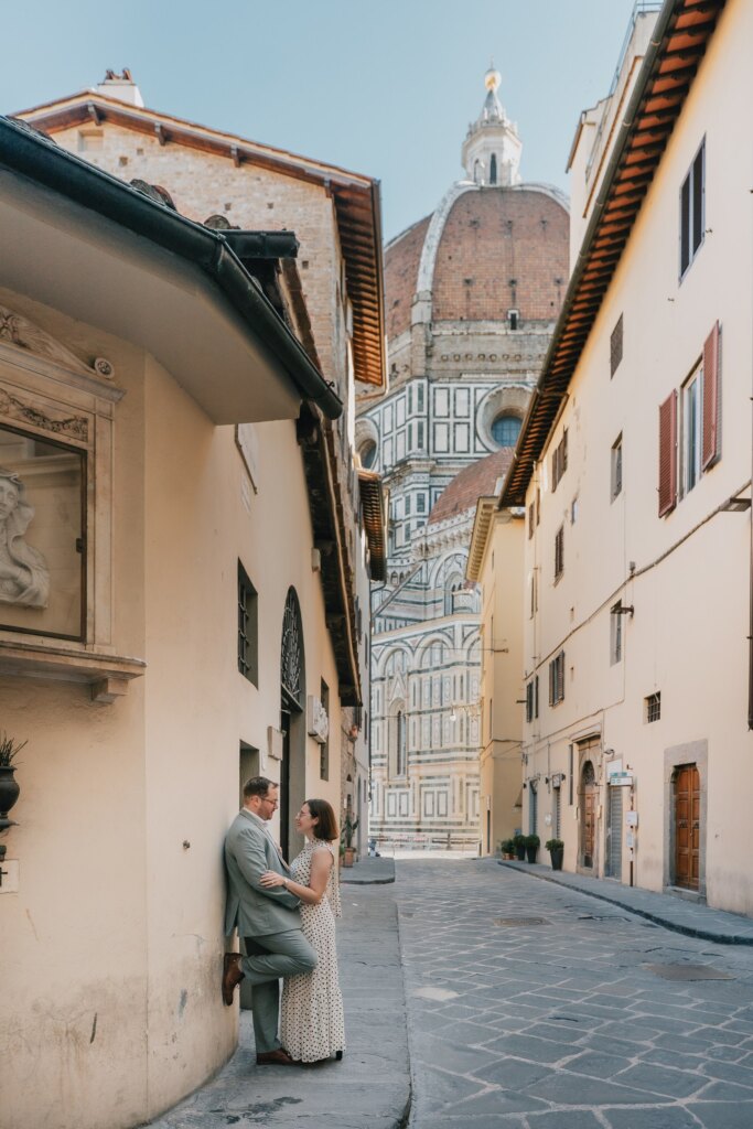 Couple in a narrow street of Florence with the Duomo dome at the end