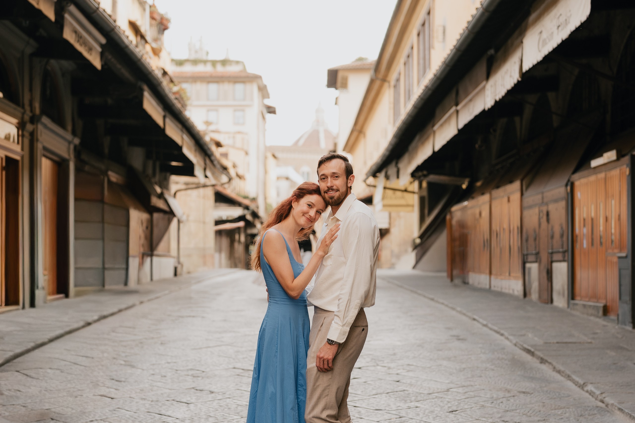 Couple embracing on Ponte Vecchio between the closed goldsmith shops, Florence