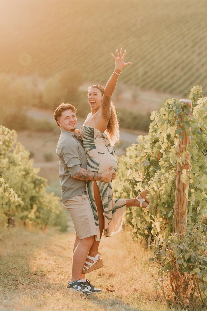 ouple celebrating in the vineyards at Castello di Gabbiano, in Chianti: he lifts her off the ground at sunset after the proposal