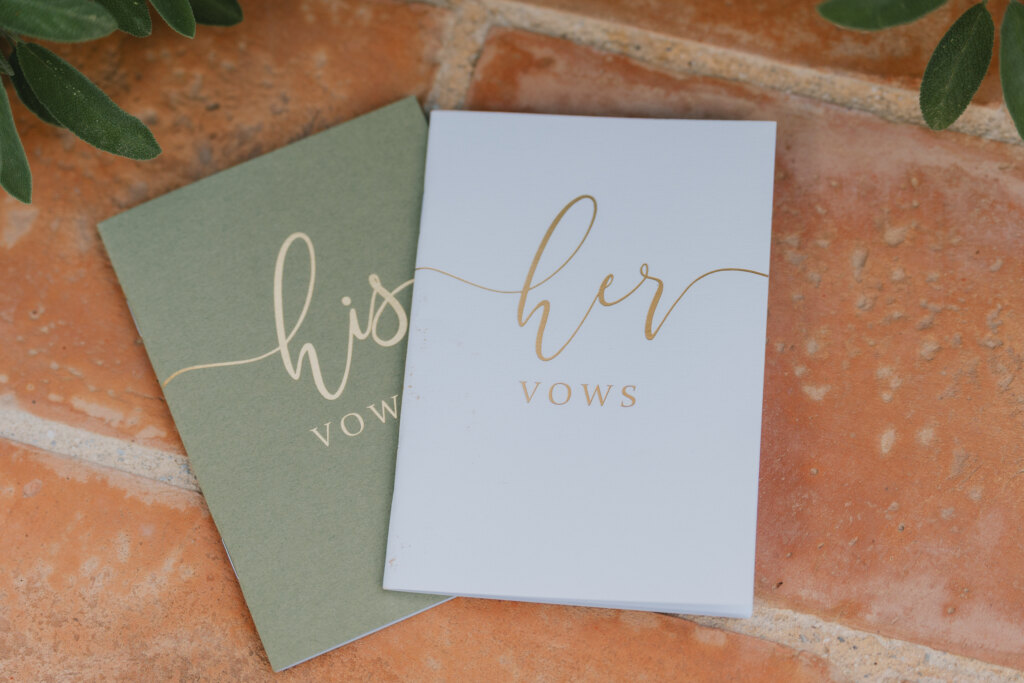 His and her vow books resting on terracotta tiles