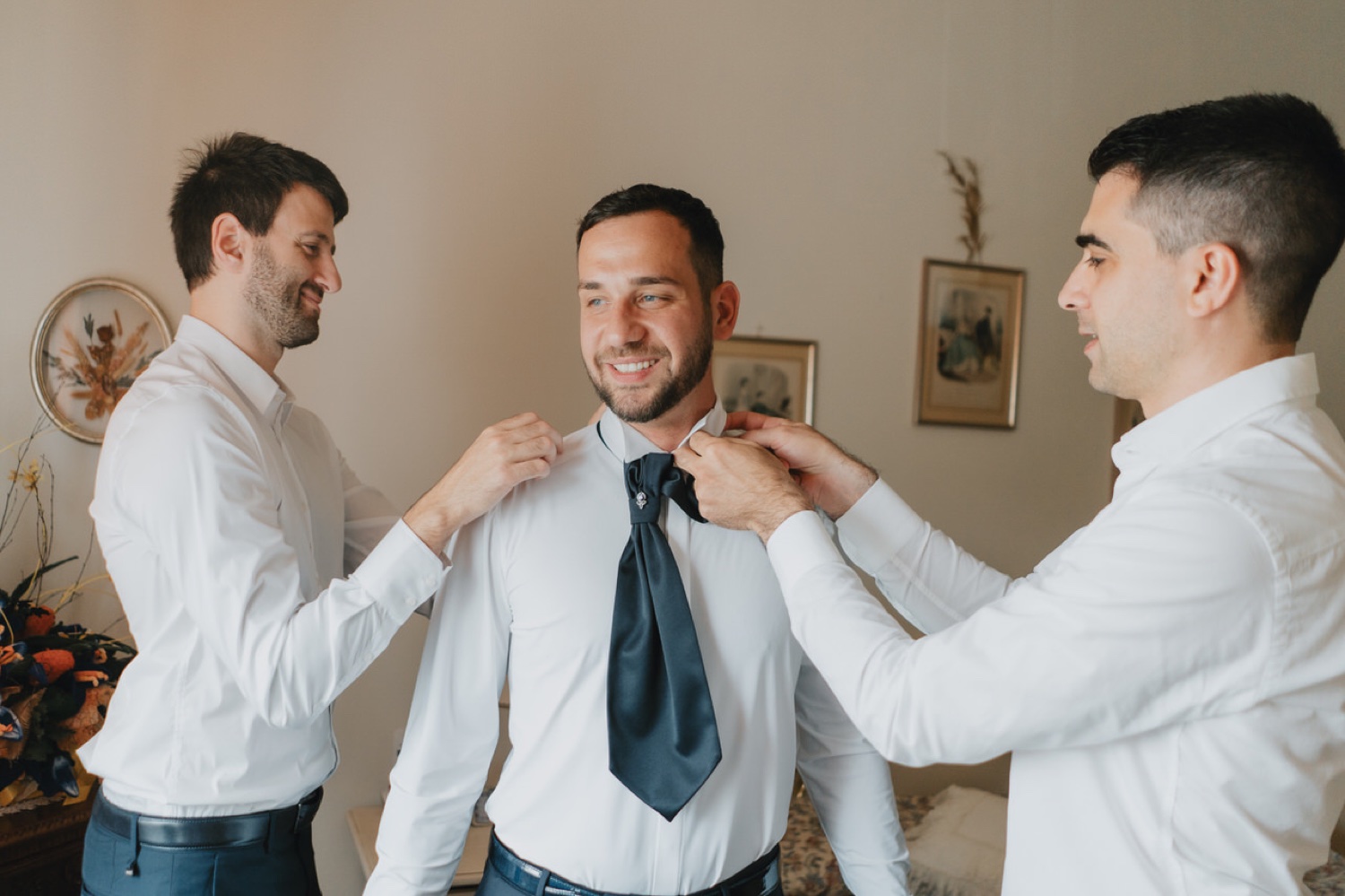 Gli amici sistemano la cravatta allo sposo