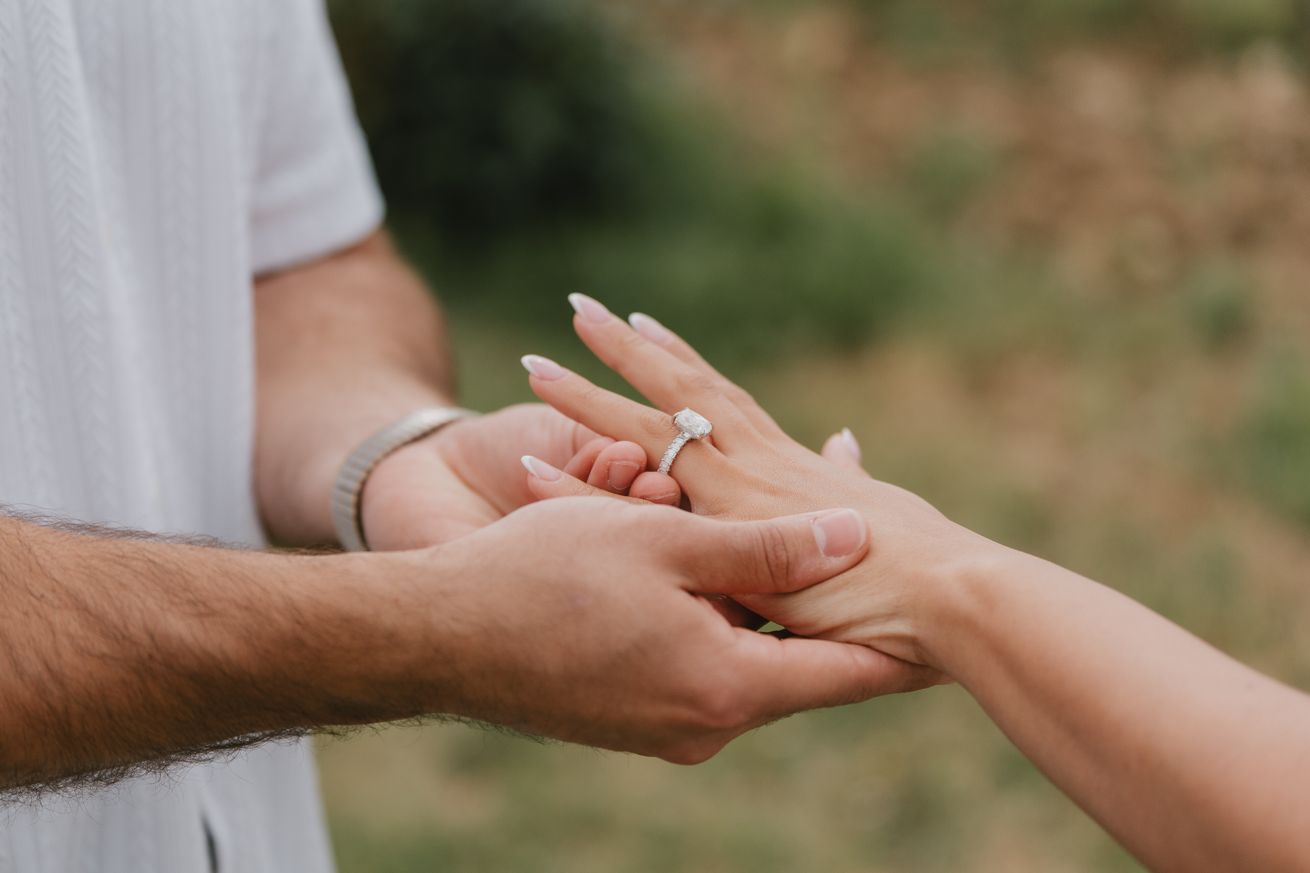 Close-up of the engagement ring and joined hands after a proposal at Cinciano, Chianti