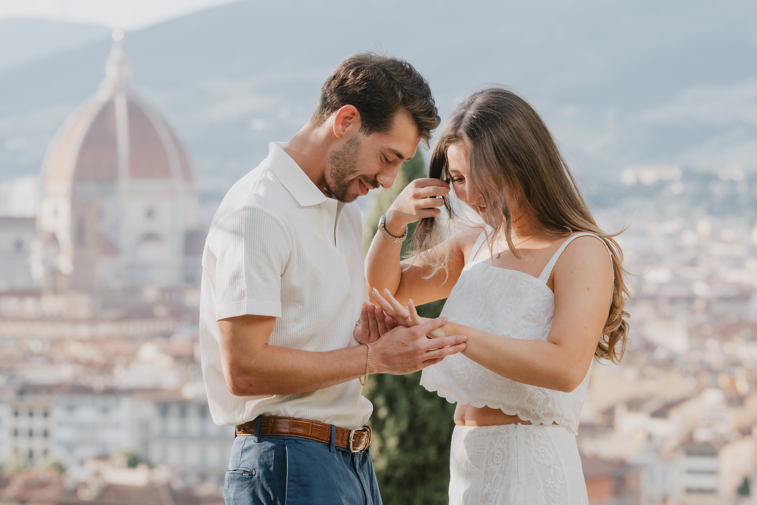 He slips the ring on her finger, the Duomo of Florence softly blurred behind