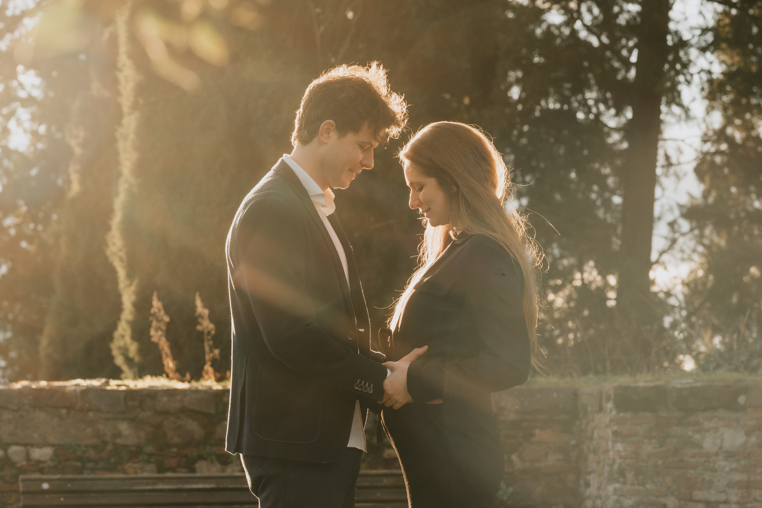 Couple close together in backlight on a Florence terrace after the proposal