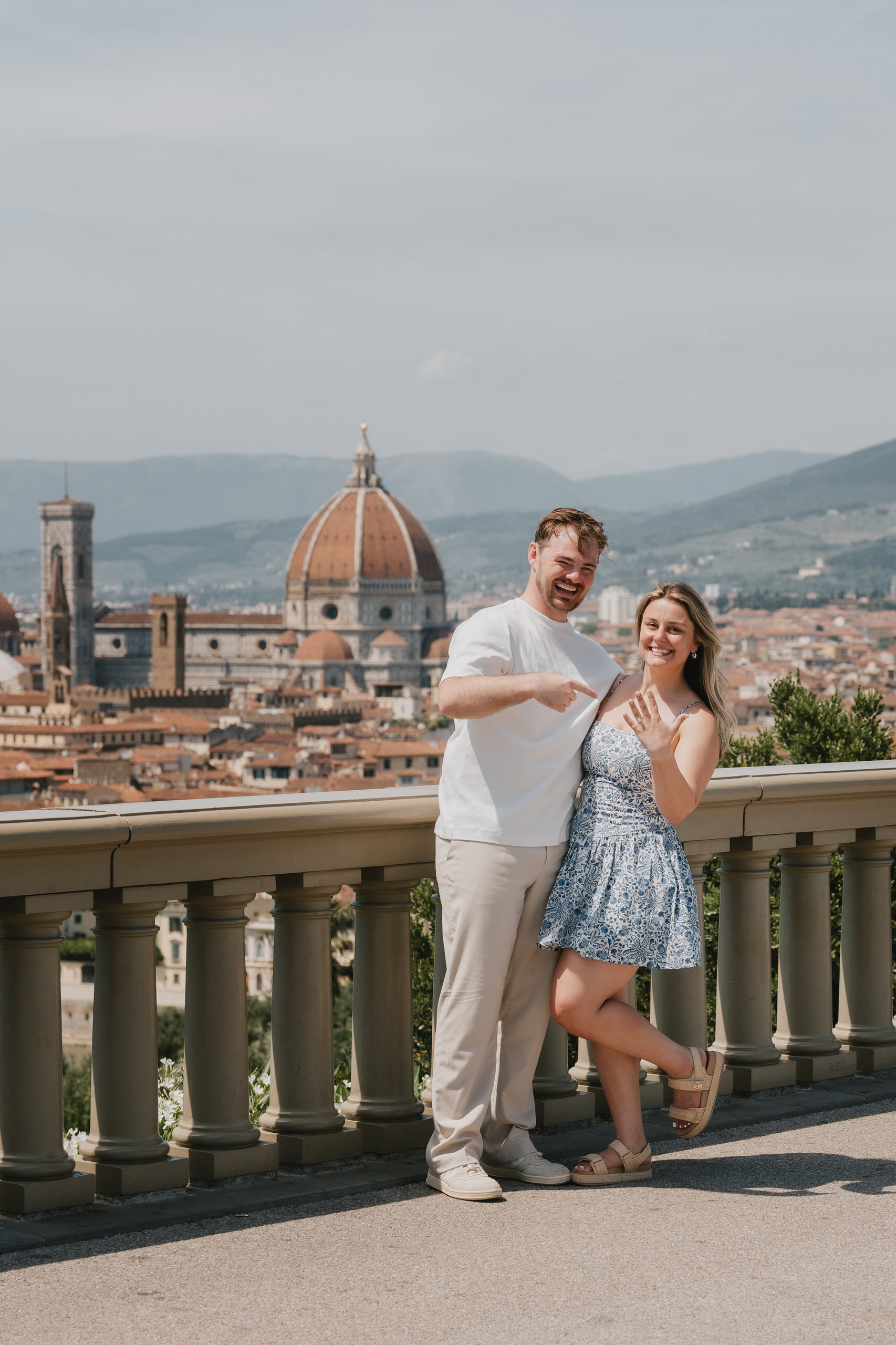 Newly engaged couple at a balustrade with the Duomo and Palazzo Vecchio behind