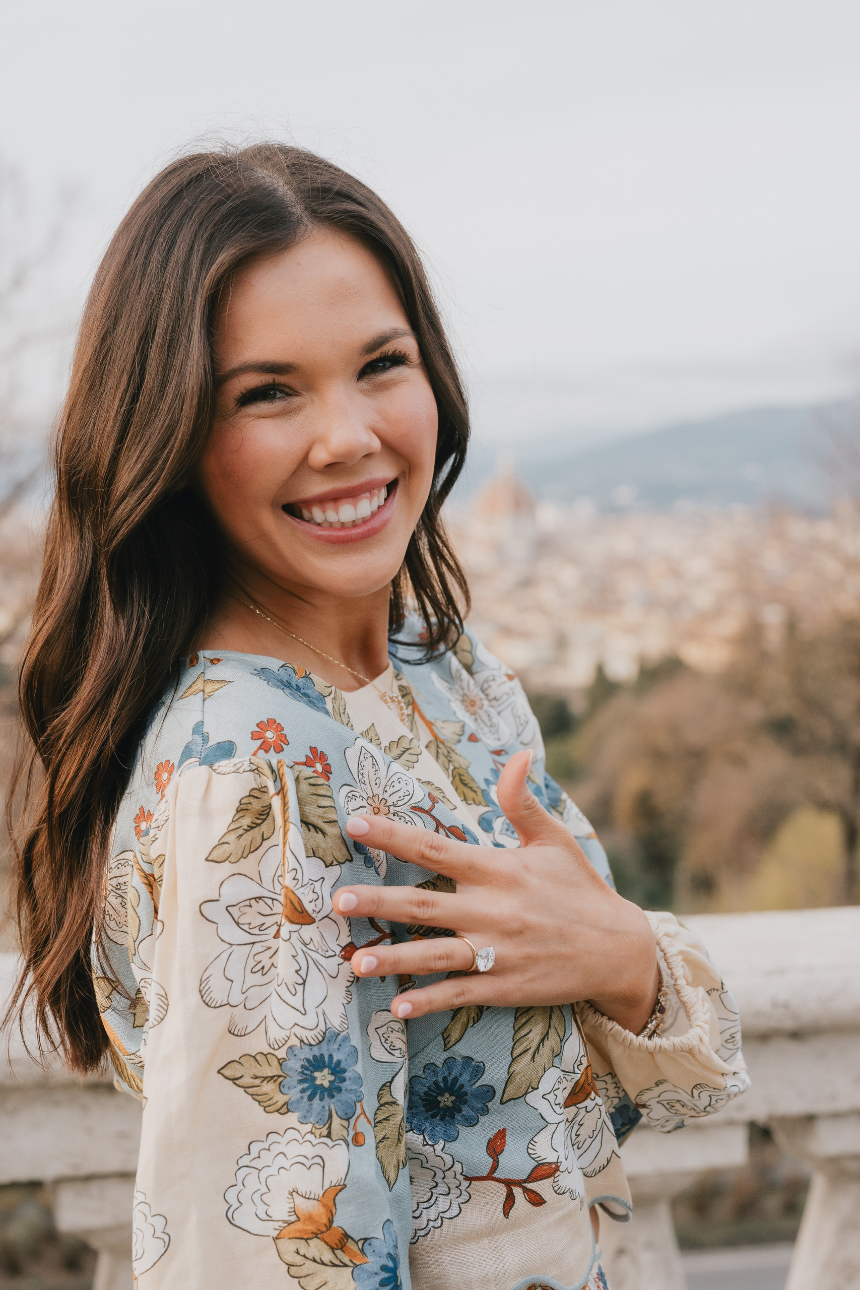 Portrait of her smiling with the ring after a proposal above Florence