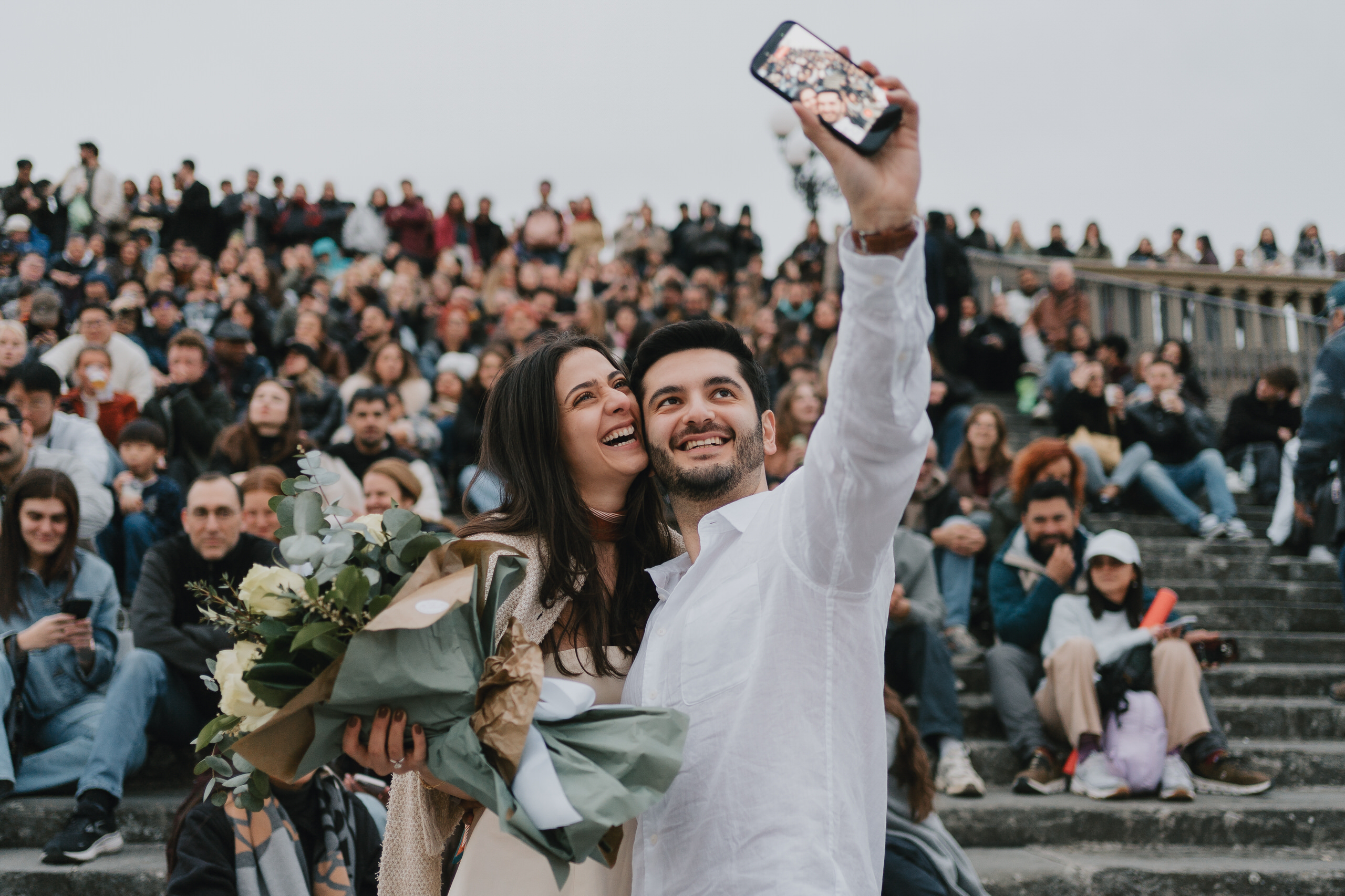 Selfie with flowers on the crowded steps above Florence after a proposal