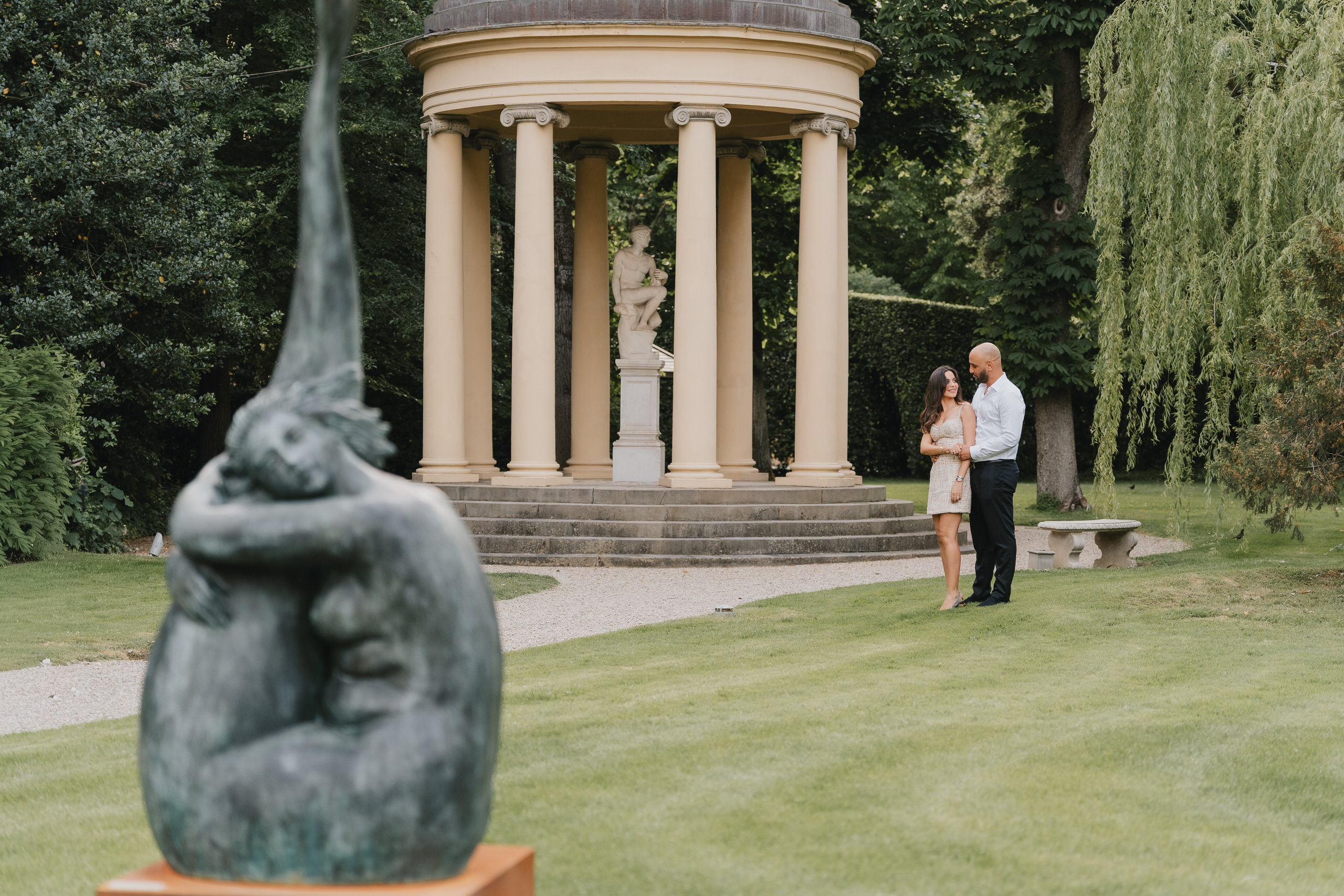 Couple by the small temple in the park of the Four Seasons Hotel Florence