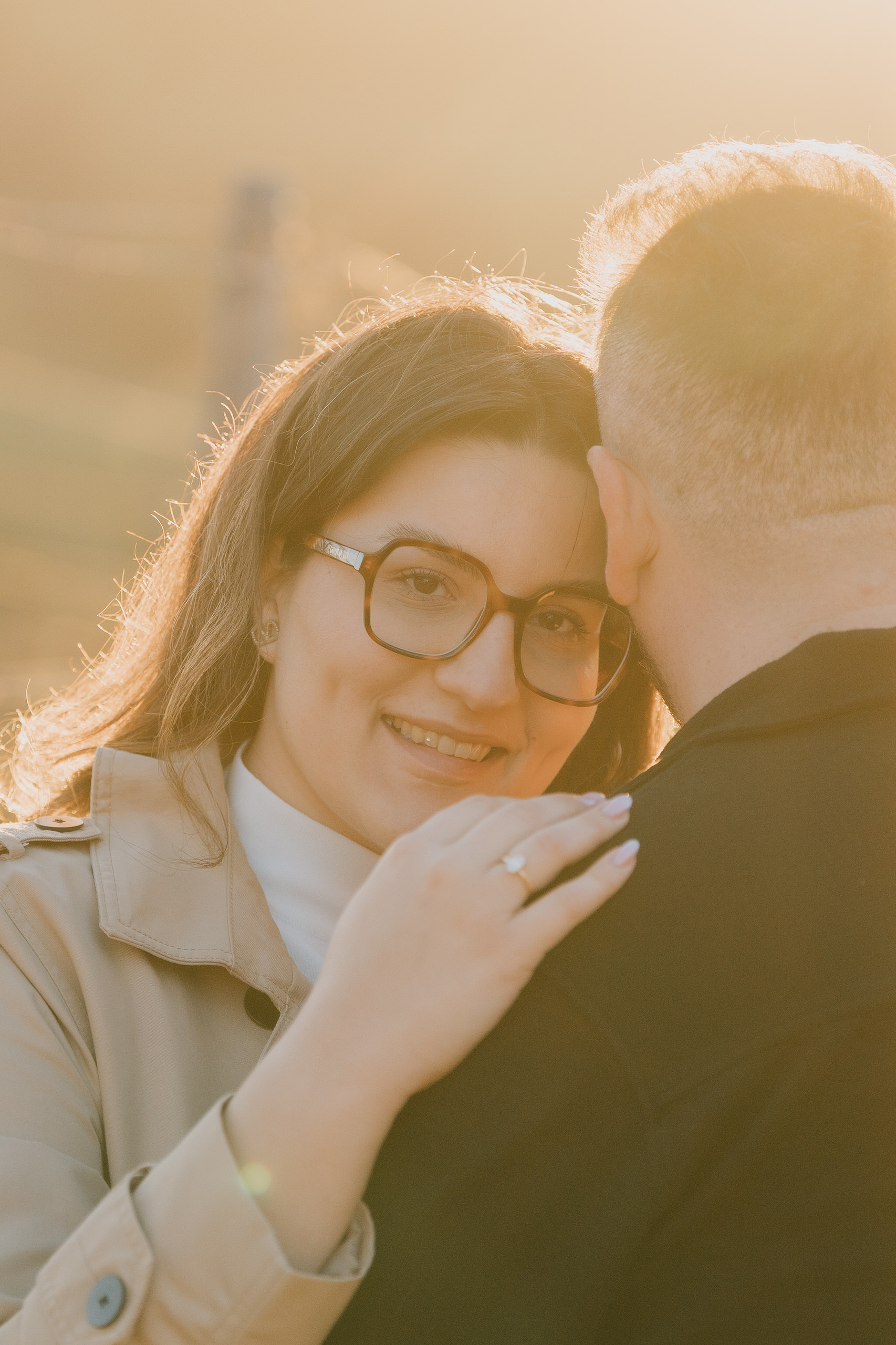 Close portrait of her with the ring, warm backlight, after a proposal at Poggio Borgoni