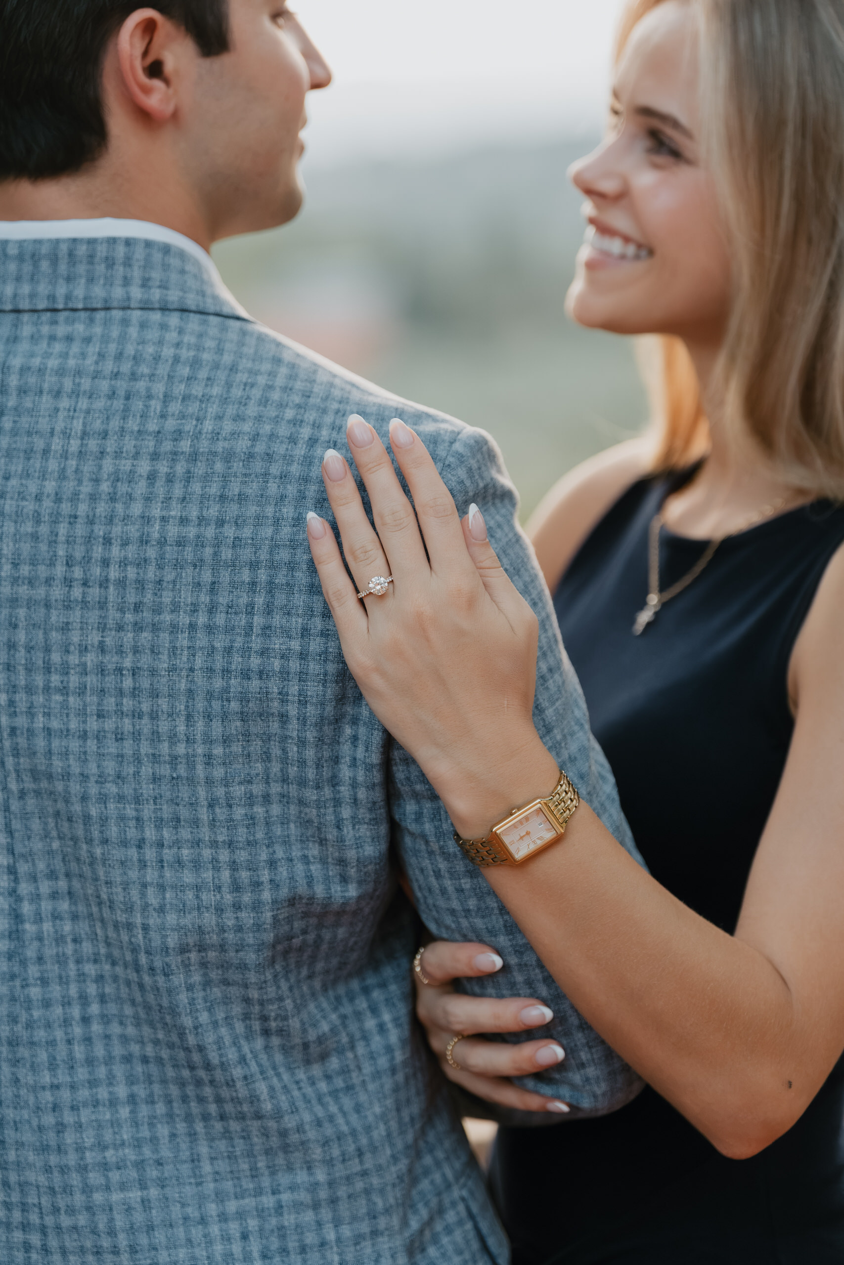 Her hand with the ring on his shoulder after the proposal at Villa Agape