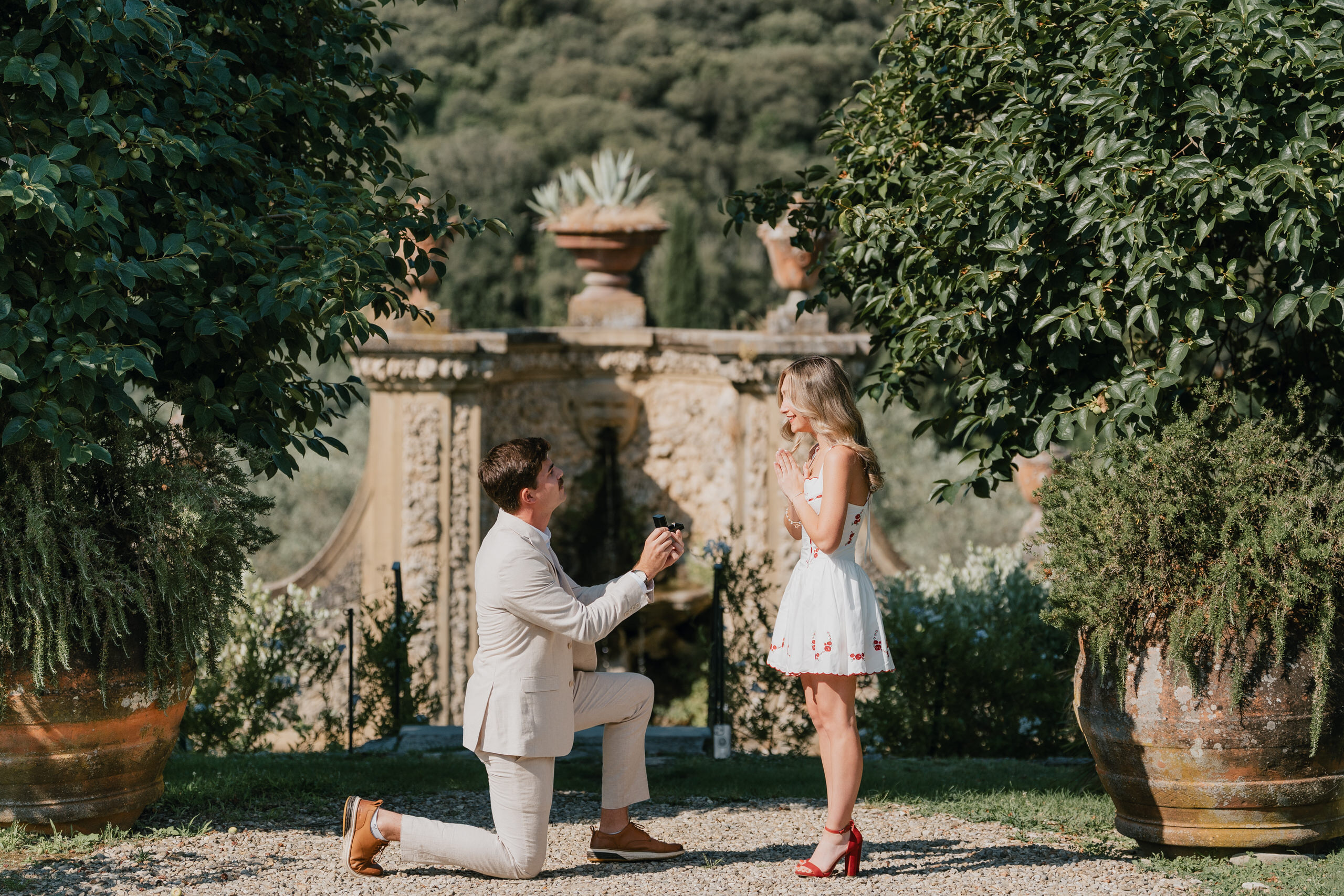 He kneels in front of the fountain at Villa Medicea di Lilliano