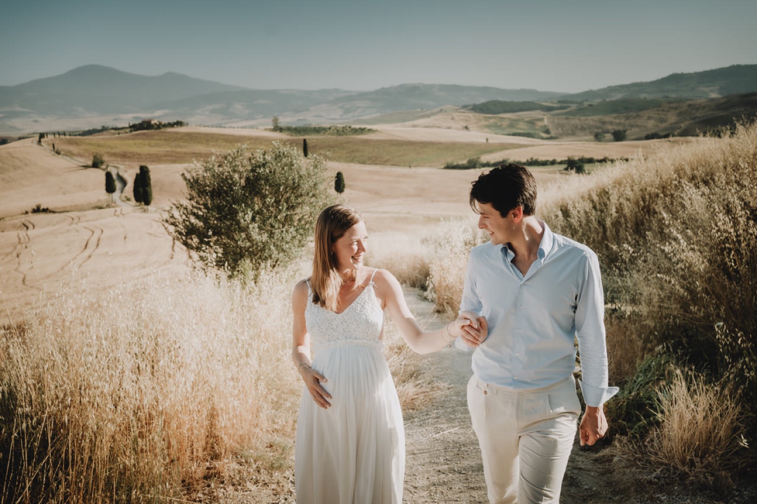 Couple laughing in the fields near Pienza