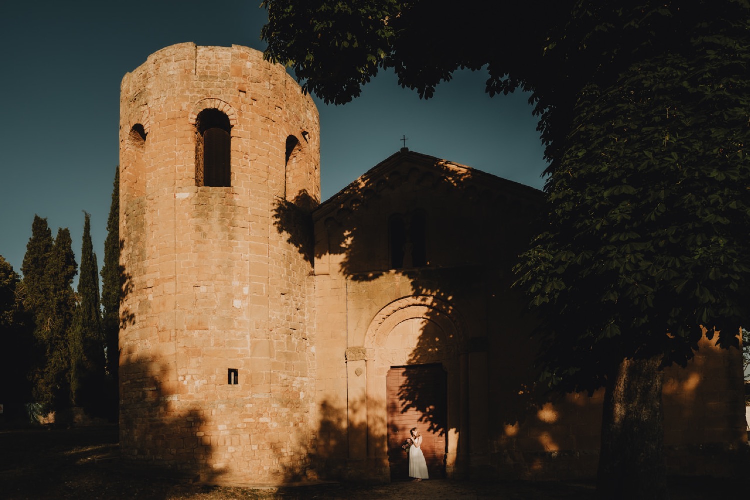 Old stone tower lit by the last sun near Pienza
