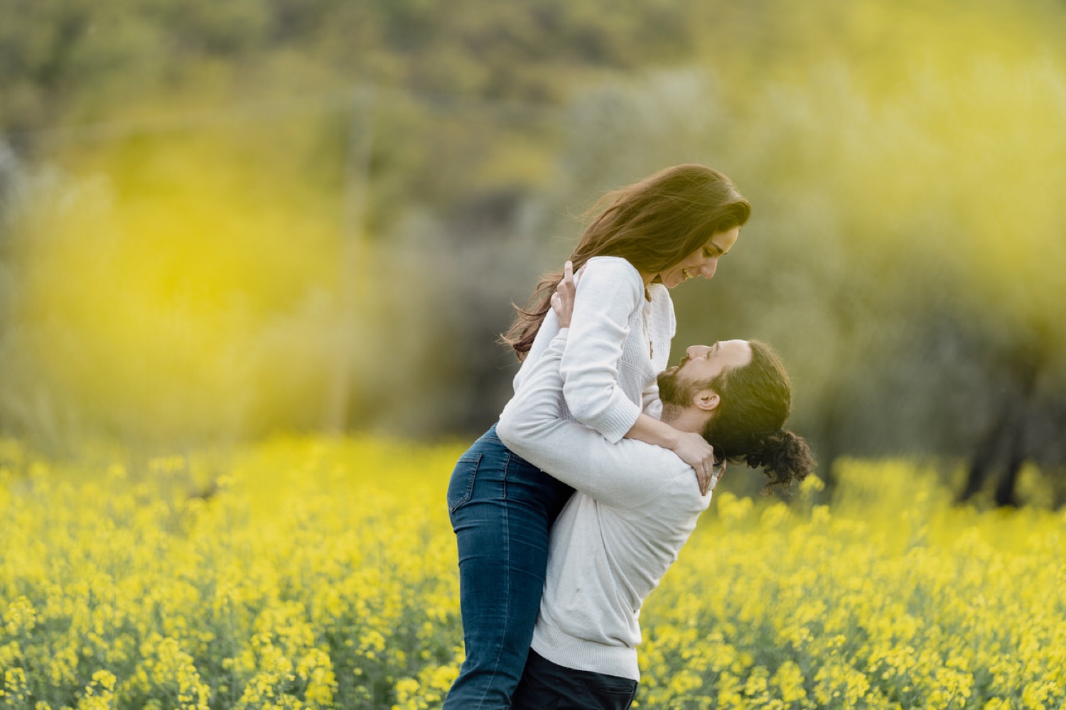 He lifts her in the flowering field